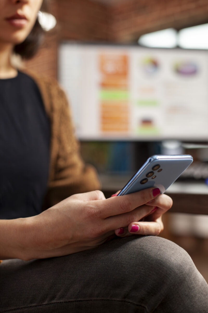 Businesswoman using cellphone in office